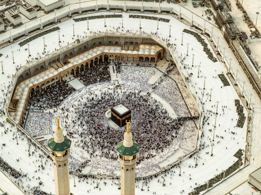 Aerial photo of the Holy Kaaba in Mecca, showing pilgrims during Hajj or Umrah, showcasing Islamic architecture.